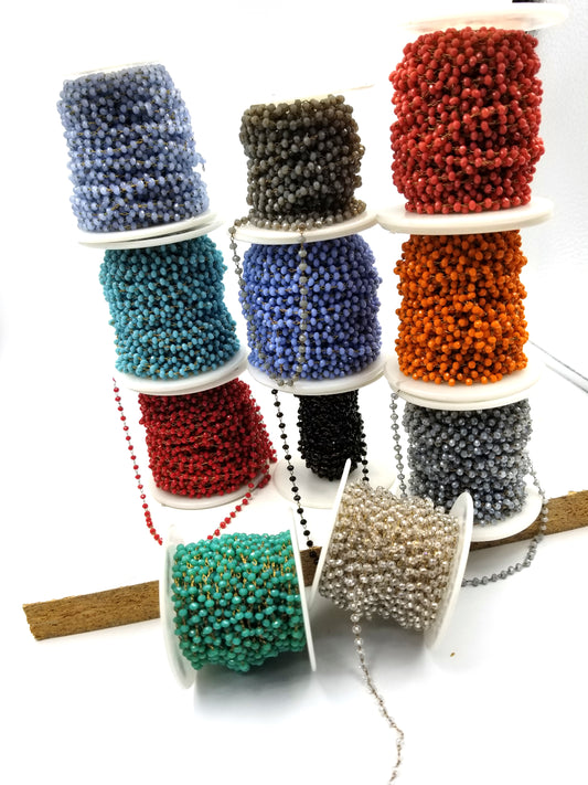Spools of faceted glass bead rosary chain in assorted colors.”