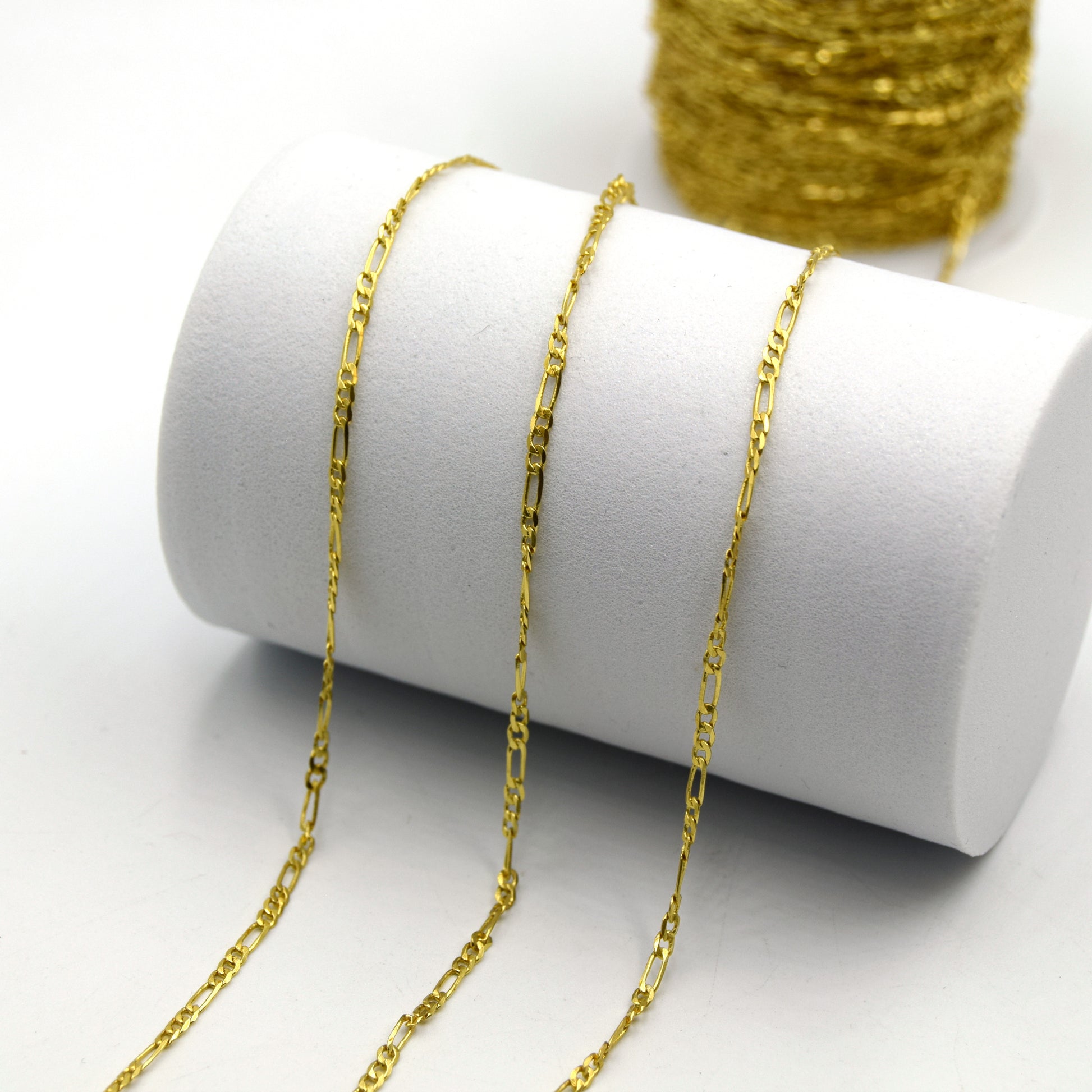 This is a picture of gold plated figaro link chain that is used to make necklaces, anklets, and bracelets.
