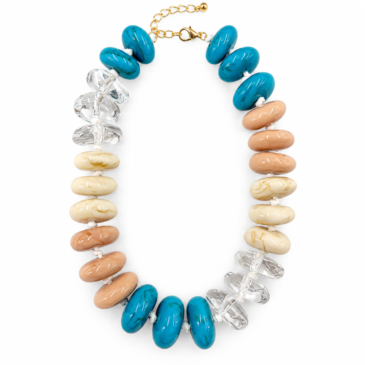 A statement necklace featuring turquoise blue oval beads, natural tan and cream stone beads, and clear faceted crystal chips, completed with a gold-tone chain and clasp.