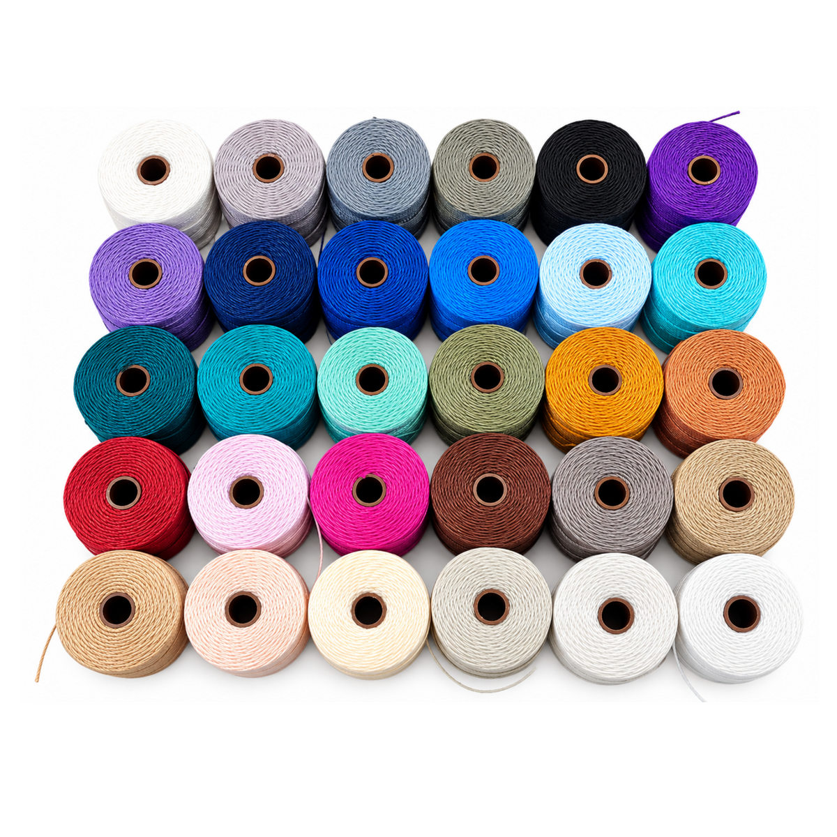 Assorted colors of Beadsmith S-Lon 210 nylon jewelry cord arranged in spools