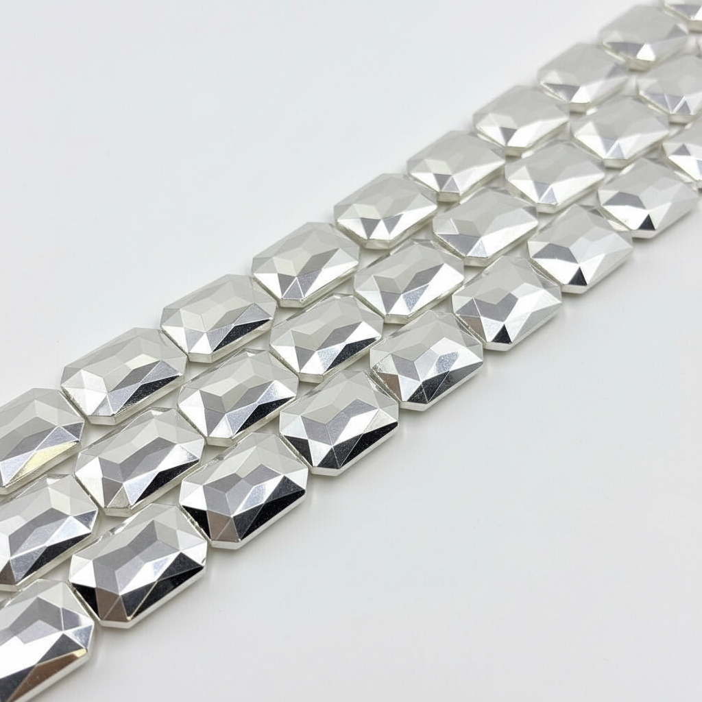 Large silver faceted crystal glass beads on strands with white background