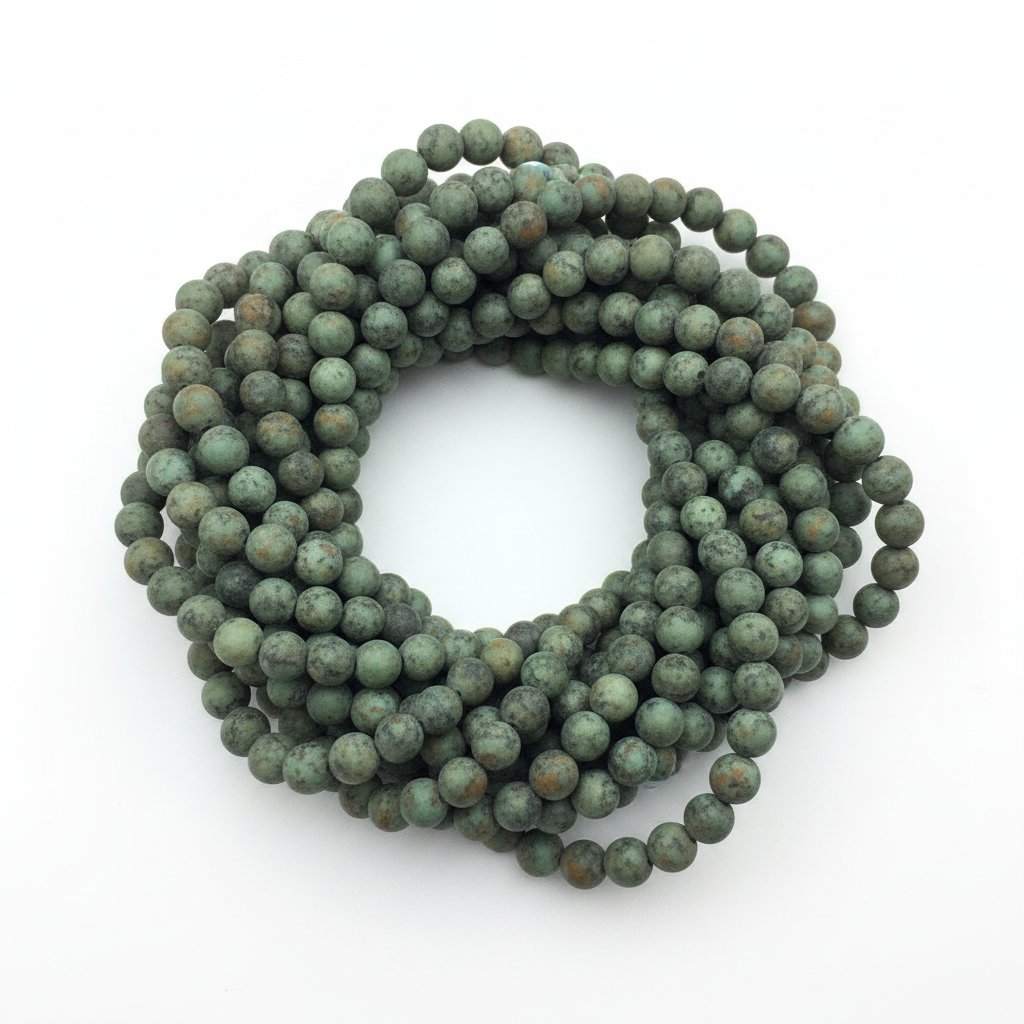 "Matte African turquoise jasper bead strands flat lay on white background"