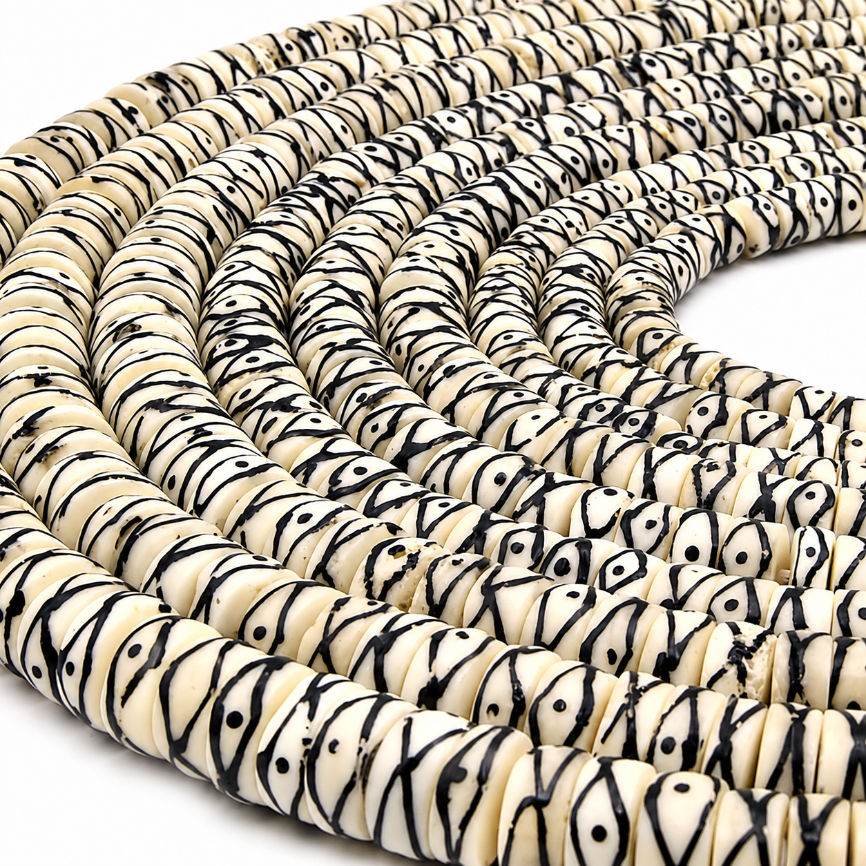 "White cream batik heishi bone beads with black tribal X dot pattern, coiled strand, 5mm heishi shape handmade"