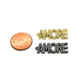 A 14K gold charm shaped into the word "Amore", perfect for expressing your love and affection. The charm is placed next to a penny for sizing reference.