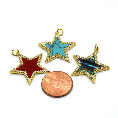beautiful gold-plated gemstone star-shaped pendant with a sparkling cubic zirconia border, perfect for jewelry making and adding a touch of sparkle to your look. Pendants are placed next to a penny for size reference