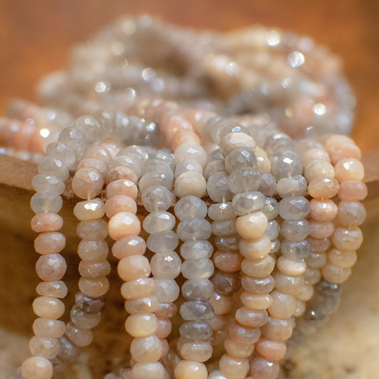 These 8mm faceted rondelle mystic coated mixed moonstone beads are the perfect addition to any jewelry project. The stones feature a variety of colors including gray, peach, and white, and each one has been faceted for extra sparkle. The mystic coating adds an extra layer of depth and interest to the beads, making them stand out even more.