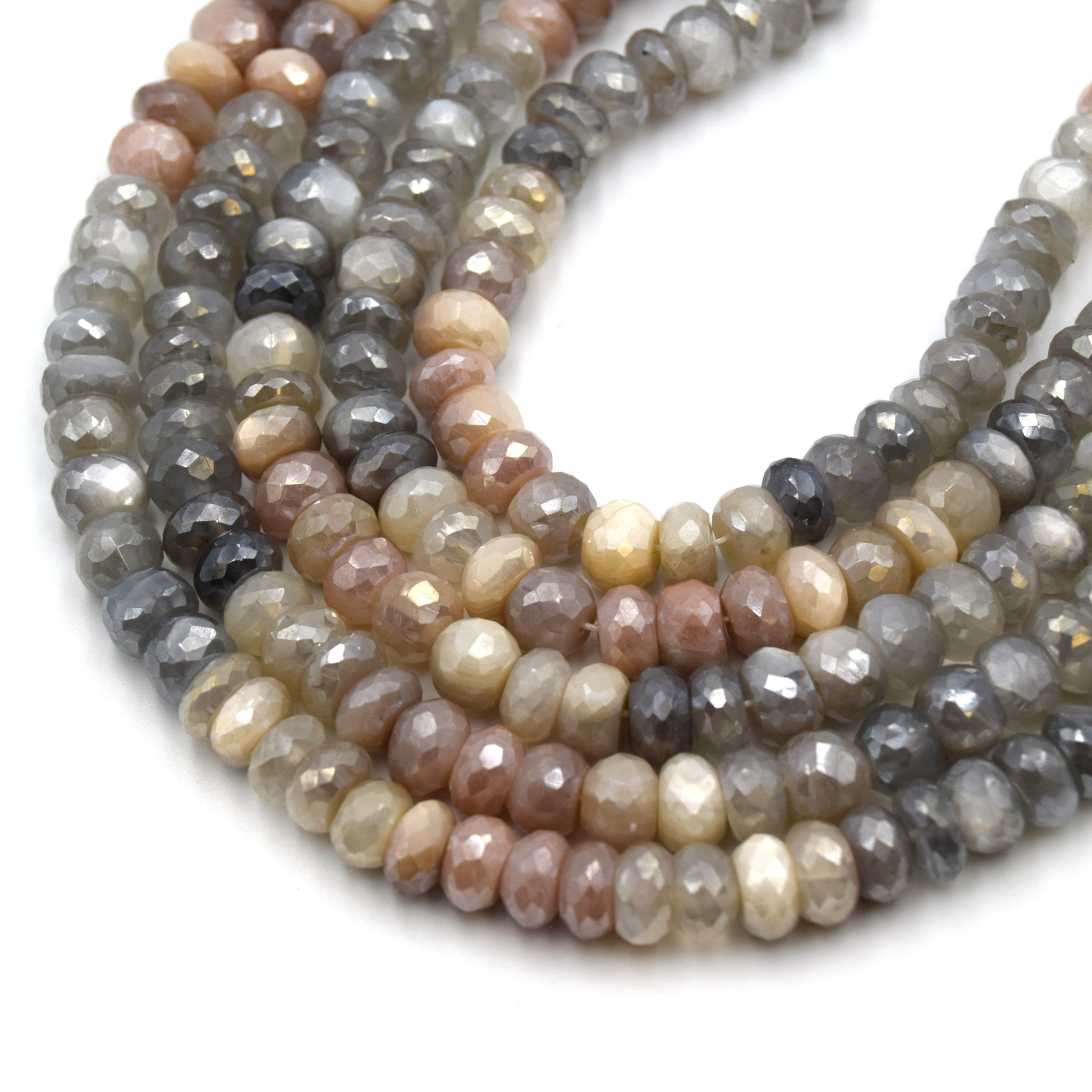 These 8mm faceted rondelle mystic coated mixed moonstone beads are the perfect addition to any jewelry project. The stones feature a variety of colors including gray, peach, and white, and each one has been faceted for extra sparkle. The mystic coating adds an extra layer of depth and interest to the beads, making them stand out even more.