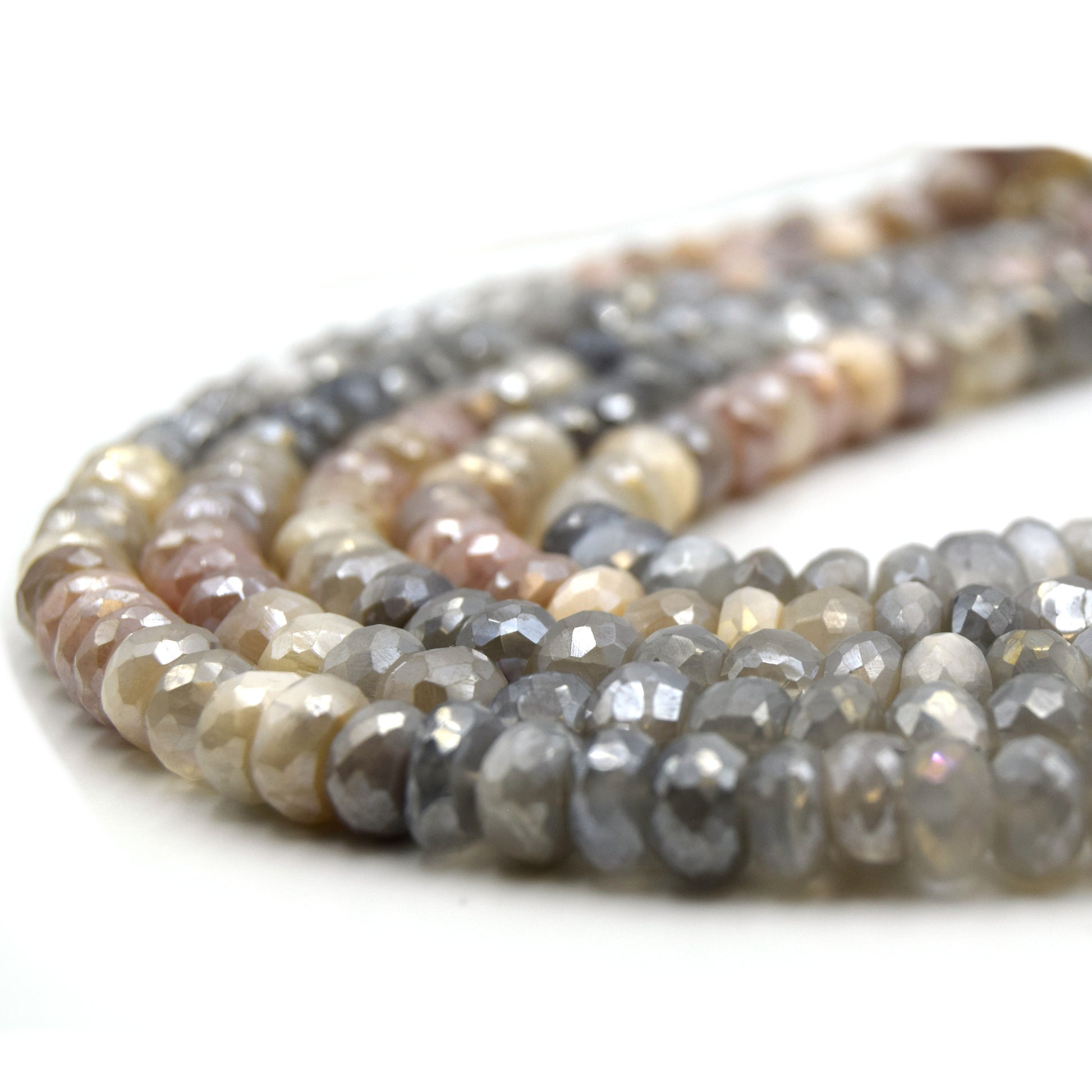 These 8mm faceted rondelle mystic coated mixed moonstone beads are the perfect addition to any jewelry project. The stones feature a variety of colors including gray, peach, and white, and each one has been faceted for extra sparkle. The mystic coating adds an extra layer of depth and interest to the beads, making them stand out even more.