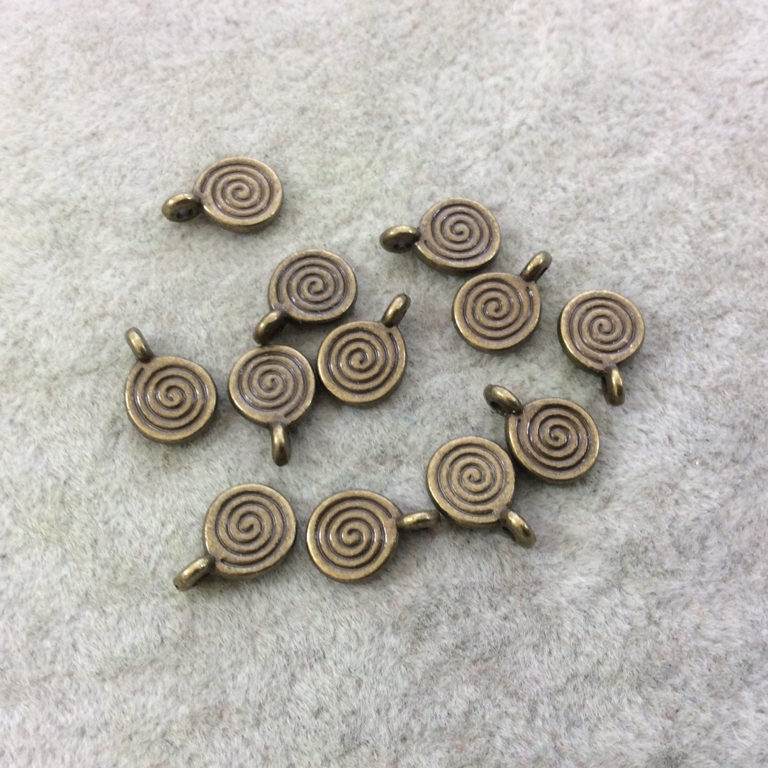 Bulk Pack of 8mm Antique Brass Plated Tibetan Silver Detailed Swirl/Spiral Engraved Round Shaped Focal Charms/Pendants - Sold in Packs of 12