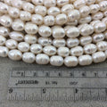 10mm-12mm AB Quality Natural Freshwater White Rice/Oval Shaped Beads - 14.25" Strand (Approx. 33 Beads) - Sold by the Strand