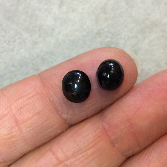 Matching Pair "G" of AAA Oval Shaped Black Star Sapphire Flat Back Cabochons - Measuring 7mm x 8mm, 5mm Dome Height - Natural Gemstone Cabs