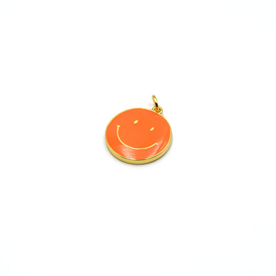 This gold plated orange enamel charm is shaped like a smiley face and is perfect for making jewelry.