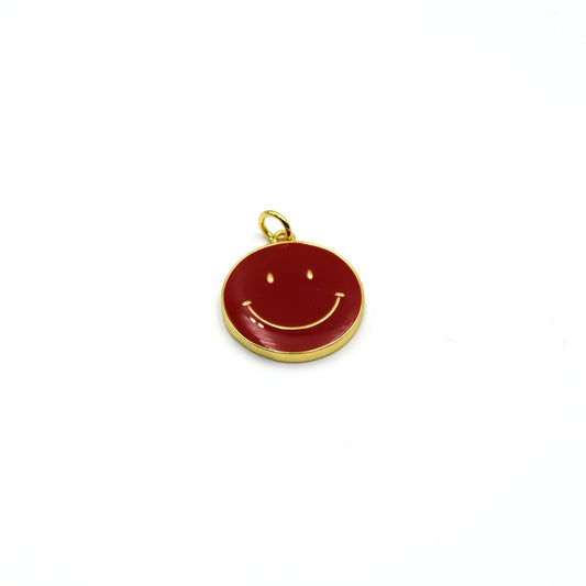 This gold plated red enamel charm is shaped like a smiley face and is perfect for making jewelry.