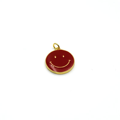 This gold plated red enamel charm is shaped like a smiley face and is perfect for making jewelry.