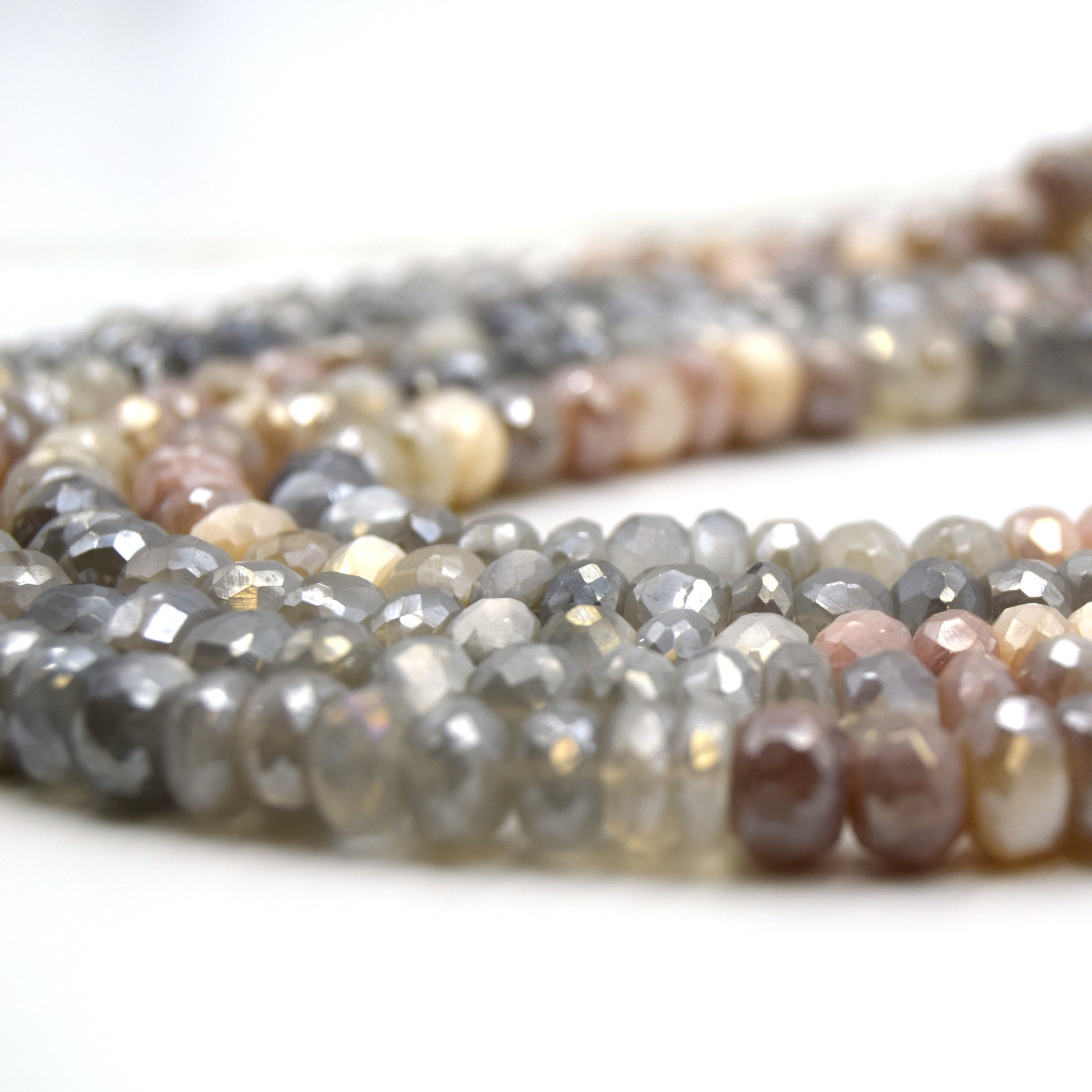 These 8mm faceted rondelle mystic coated mixed moonstone beads are the perfect addition to any jewelry project. The stones feature a variety of colors including gray, peach, and white, and each one has been faceted for extra sparkle. The mystic coating adds an extra layer of depth and interest to the beads, making them stand out even more.