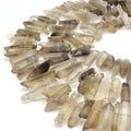 A set of gray aura quartz stick beads, perfect for jewelry making or crafting projects.