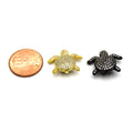  This image shows a set of cubic zirconia turtle shaped beads. The beads are gold and black in color and have an intricate, detailed design. The beads have a glossy finish and feature small cubic zirconia stones that give the turtles an extra sparkle. They are perfect for jewelry making and other craft projects.