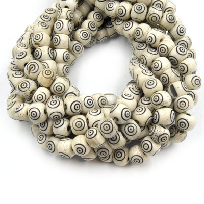 white bone beads with black carving